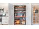 Organized walk-in pantry with custom wood shelves, providing ample storage space for all your kitchen essentials at 1124 Culver Spring Way, Charlotte, NC 28215