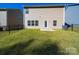 Well-maintained backyard with green grass, patio, and partial fence at 113 Fosters Glen Pl, Mooresville, NC 28115