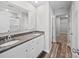 This bathroom features a double sink with granite countertop and wood look flooring at 113 Fosters Glen Pl, Mooresville, NC 28115