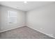 This bedroom features plush carpet, a window for natural light, and neutral walls at 113 Fosters Glen Pl, Mooresville, NC 28115