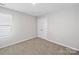 Neutral bedroom featuring a window, carpeted floor, and double door closet at 113 Fosters Glen Pl, Mooresville, NC 28115