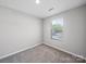 This bedroom features plush carpet, a window for natural light, and neutral walls at 113 Fosters Glen Pl, Mooresville, NC 28115
