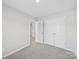This bedroom features plush carpet, a closet, and neutral walls at 113 Fosters Glen Pl, Mooresville, NC 28115