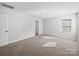 This bedroom features plush carpet, a window for natural light, and a closet at 113 Fosters Glen Pl, Mooresville, NC 28115