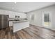 Modern kitchen features an island and an exterior door at 113 Fosters Glen Pl, Mooresville, NC 28115