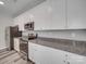 Bright kitchen with stainless appliances, stone counters, and white cabinets at 113 Fosters Glen Pl, Mooresville, NC 28115