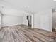 Spacious living area with wood-look floors, opening to the stairwell and kitchen area at 113 Fosters Glen Pl, Mooresville, NC 28115