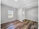 Versatile room features stylish floors, a window, and neutral walls at 113 Fosters Glen Pl, Mooresville, NC 28115