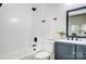 Modern bathroom featuring a sleek tub and shower combination, contemporary fixtures, and a vanity with a black framed mirror at 113 Woodside Ave, Gastonia, NC 28054