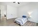Cozy bedroom with wood-look flooring, neutral decor, and a ceiling fan, leading to the closet space at 113 Woodside Ave, Gastonia, NC 28054