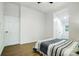 Simple bedroom showcasing neutral decor, wood-look flooring, multiple closets, and natural light through the window at 113 Woodside Ave, Gastonia, NC 28054