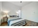 Well-lit bedroom showcasing neutral decor, wood-look flooring, with bedside lamps, creating a soothing atmosphere at 113 Woodside Ave, Gastonia, NC 28054