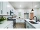 Contemporary kitchen featuring white cabinetry, a tile backsplash, and stainless appliances at 113 Woodside Ave, Gastonia, NC 28054