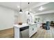 Open kitchen with stainless steel appliances, quartz countertop island, and seamlessly connects to the adjacent living spaces at 113 Woodside Ave, Gastonia, NC 28054