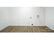 An empty laundry room with hard surface floors, white walls and hookups for washer and dryer at 113 Woodside Ave, Gastonia, NC 28054