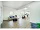 Open-concept living area flowing into a modern kitchen with hardwood floors at 113 Woodside Ave, Gastonia, NC 28054