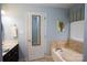 Inviting bathroom with soaking tub, tile accents, and a window for natural light at 115 Stumpy Creek Rd, Mooresville, NC 28117
