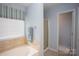 Bright bathroom featuring a tub, shower, and modern towel bar, perfect for relaxation at 115 Stumpy Creek Rd, Mooresville, NC 28117