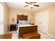 Cozy bedroom featuring a ceiling fan, neutral walls, and a large window with natural light at 115 Stumpy Creek Rd, Mooresville, NC 28117