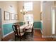 Bright dining room with natural light, wainscotting and seating for six, perfect for Gathering meals at 115 Stumpy Creek Rd, Mooresville, NC 28117