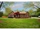 Charming single-story brick home with well-manicured lawn and mature landscaping creating a welcoming curb appeal at 115 Stumpy Creek Rd, Mooresville, NC 28117