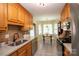 Functional kitchen with tile floors and modern stainless appliances with an adjacent breakfast area for casual dining at 115 Stumpy Creek Rd, Mooresville, NC 28117