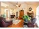 Cozy living room with vaulted ceilings, a brick fireplace, and large windows, perfect for relaxation at 115 Stumpy Creek Rd, Mooresville, NC 28117