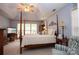 Comfortable main bedroom featuring vaulted ceiling, four-poster bed, and inviting decor at 115 Stumpy Creek Rd, Mooresville, NC 28117