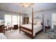 Spacious main bedroom with vaulted ceiling, four-poster bed, and ample natural light at 115 Stumpy Creek Rd, Mooresville, NC 28117