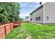 Nice backyard with green lawn, a wooden fence, and a red deck for outdoor activities at 1177 Ellis Pond Dr, Rock Hill, SC 29730