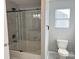 Modern bathroom design featuring a glass-enclosed tub and shower, tile surround, and window at 1177 Ellis Pond Dr, Rock Hill, SC 29730