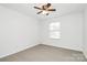 Clean bedroom featuring a ceiling fan, window, and neutral carpet at 1177 Ellis Pond Dr, Rock Hill, SC 29730