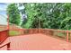 Well-maintained red wooden deck perfect for outdoor entertaining, with backyard views at 1177 Ellis Pond Dr, Rock Hill, SC 29730
