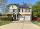 Charming two-story home with stone accents, solar panels, attached two-car garage and well-manicured lawn at 1177 Ellis Pond Dr, Rock Hill, SC 29730