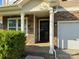 Inviting front porch with stone accents and black front door at 1177 Ellis Pond Dr, Rock Hill, SC 29730