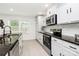 Bright kitchen with stainless steel appliances, granite countertops and white cabinets, a chef's dream at 1177 Ellis Pond Dr, Rock Hill, SC 29730