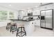 Modern kitchen features a large island with seating, stainless steel appliances, and abundant natural light at 1177 Ellis Pond Dr, Rock Hill, SC 29730