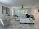 Spacious living room with plush seating, contemporary accents, and natural light from large windows at 1177 Ellis Pond Dr, Rock Hill, SC 29730