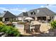 Backyard view featuring a custom pool, patio, and outdoor dining area at 129 Hunts Landing Dr, Mooresville, NC 28117