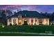 Stunning home exterior with stone accents, manicured lawn, and professional landscaping at 129 Hunts Landing Dr, Mooresville, NC 28117