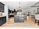 Gourmet kitchen featuring a spacious island, stainless appliances, hardwood floors and modern lighting at 129 Hunts Landing Dr, Mooresville, NC 28117