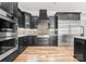 Updated kitchen with stainless steel appliances, granite countertops, modern hood and hardwood floors at 129 Hunts Landing Dr, Mooresville, NC 28117