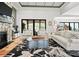 Bright living room with stone fireplace, hardwood floors, and large windows at 129 Hunts Landing Dr, Mooresville, NC 28117