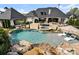 Beautiful backyard oasis featuring a large pool, jacuzzi, and ample seating at 129 Hunts Landing Dr, Mooresville, NC 28117