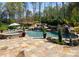 Backyard pool area featuring a waterfall and lush landscaping at 129 Hunts Landing Dr, Mooresville, NC 28117