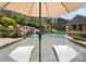 Luxury pool with sun chairs in the water and a lush waterfall feature at 129 Hunts Landing Dr, Mooresville, NC 28117