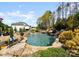 Backyard pool with waterfall feature and bench at 129 Hunts Landing Dr, Mooresville, NC 28117