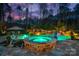A luxurious pool and spa with lush landscaping, complemented by elegant outdoor furniture at 129 Hunts Landing Dr, Mooresville, NC 28117