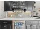 Wet bar area with beverage fridge, glass storage, wine glass rack, custom cabinets, and stone backsplash at 129 Hunts Landing Dr, Mooresville, NC 28117