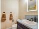 Bathroom featuring a vanity sink and toilet with coordinated wallpaper and accessories at 1309 Briarcliff Rd, Shelby, NC 28152
